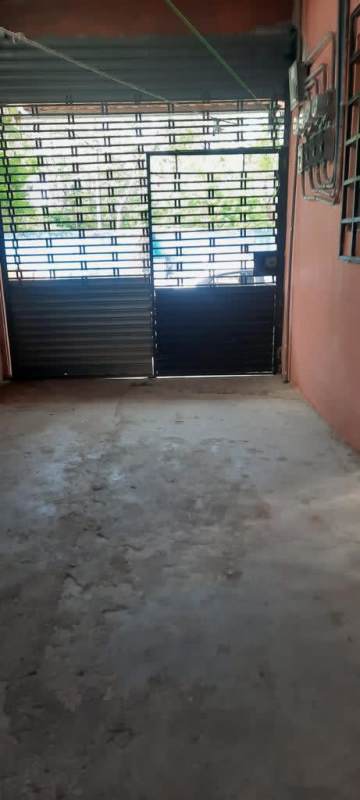 Covered garage space with security grate in single-family house for sale Panama City
