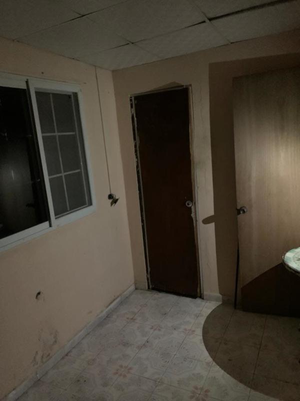 Interior small room peach-colored walls and tiled floor affordable home Panama