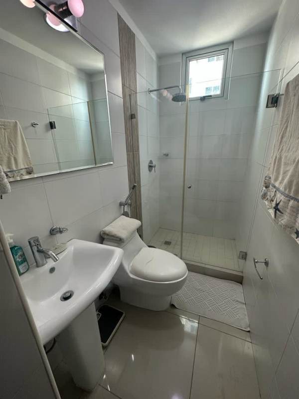 Modern bathroom with glass shower and pedestal sink PH Belle View Tower Panama City