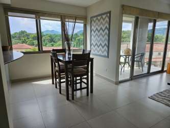 Dining area with natural light, modern furnishings, balcony with seating PH Midrise Panama Pacifico