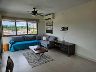 Living area with natural light, sectional sofa, ceiling fan, balcony access, PH Midrise Woodlands Panama