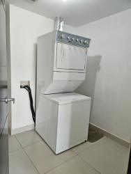 Laundry room with washer dryer in apartment PH Midrise Panama Pacifico