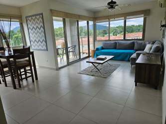Spacious living and dining room with large windows, balcony, in PH Midrise Woodlands Panama Pacifico