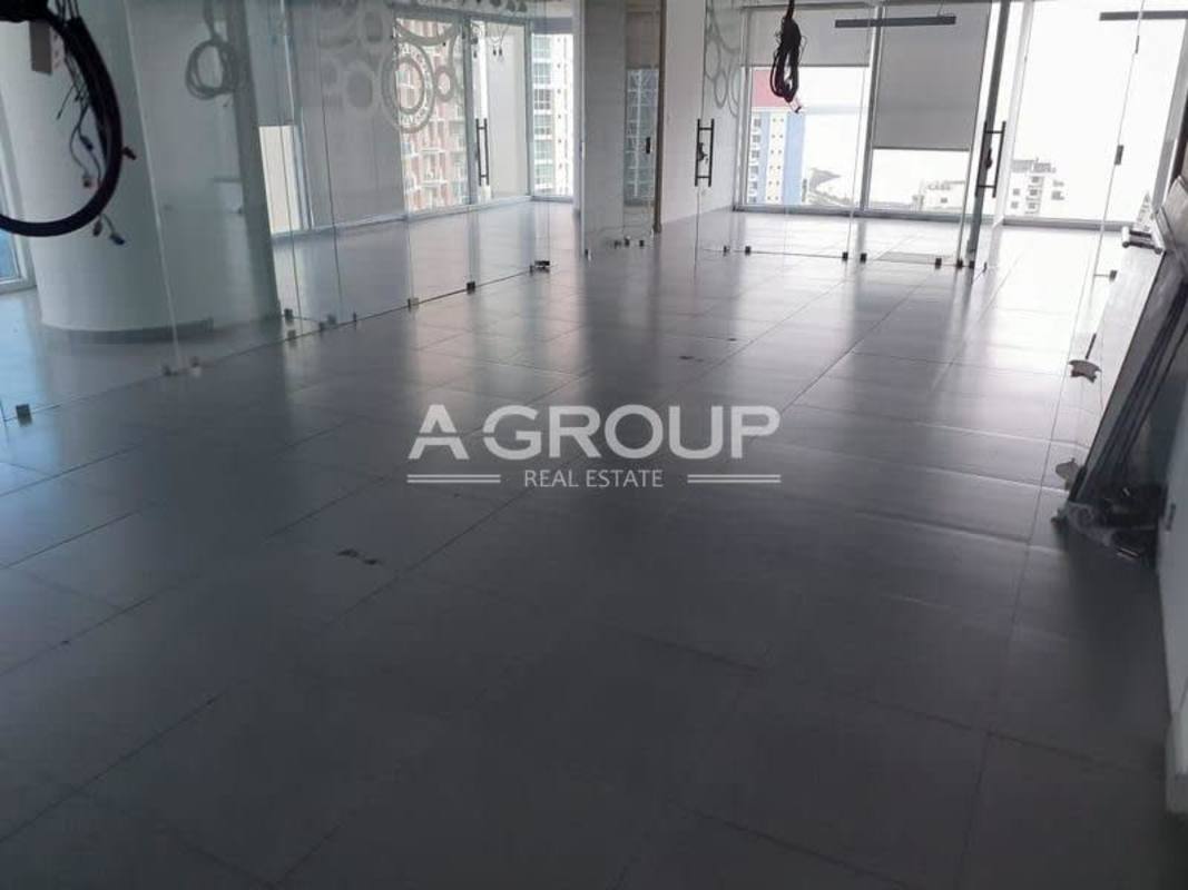 Empty commercial office with porcelain tiles and floor-to-ceiling glass partitions Oceania Business Plaza Panama