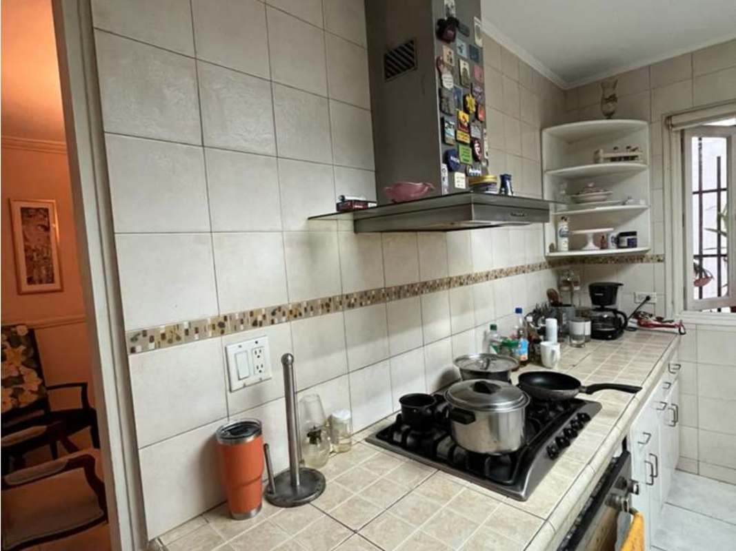 Living room with classic furnishings, chandelier, and park views in PH Villa Gabriella San Francisco Panama