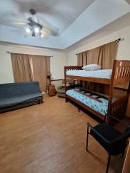 Traditional open kitchen with granite counters and wood cabinets in mountain home Altos del María