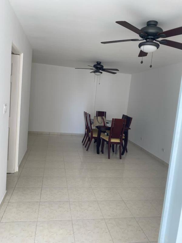 Open plan living and dining area with large windows, ceiling fan, and balcony access at PH Hills Tower Panama City