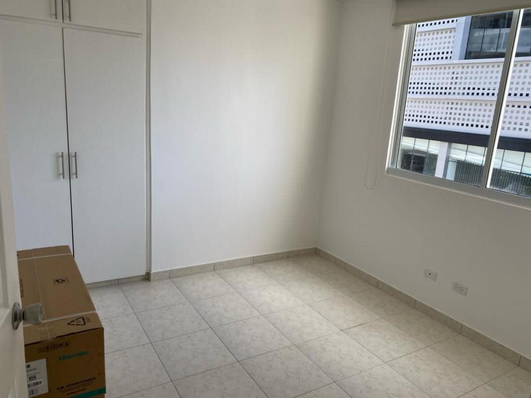 Bedroom with large built-in white closets and tile flooring at PH Hills Tower Panama