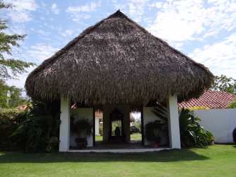 Bright tropical bedroom with wicker bed and terrace in luxury villa Buenaventura Panama