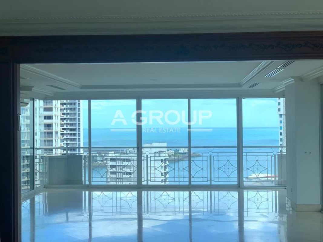 Living room with marble floors, large windows, ocean view balcony in City Tower Panama
