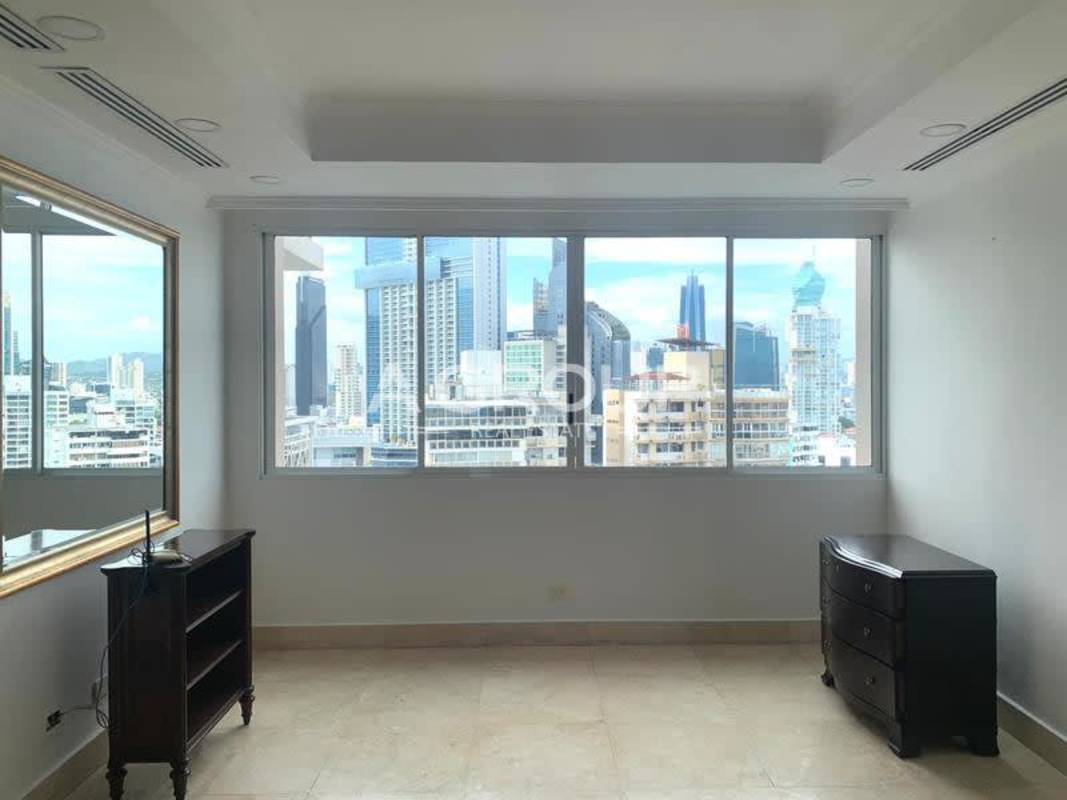 Living room with large sliding doors to balcony ocean and skyline in PH City Tower Panama