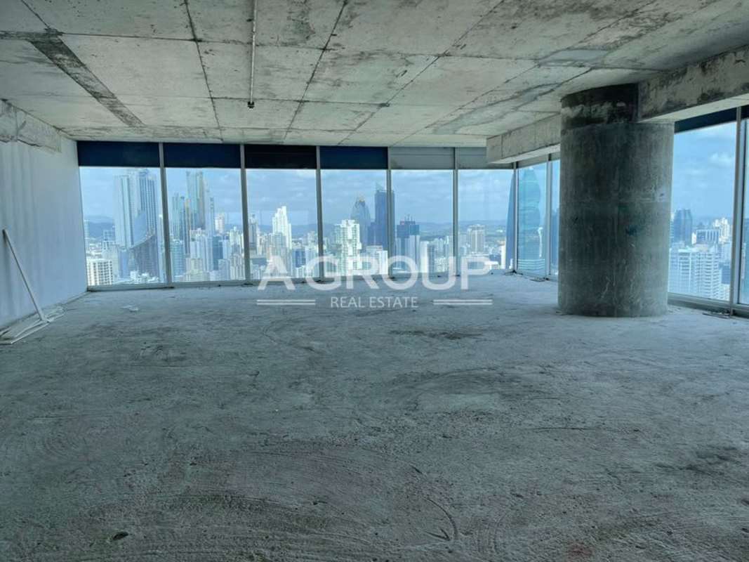 Open unfinished tower office with concrete floors and large windows in Punta Pacifica Panama