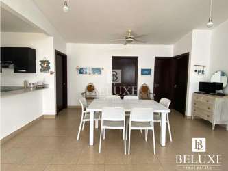 Dining area with ceiling fan connected to open concept living space