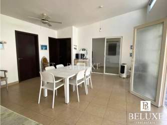 Modern dining area with white furniture and open kitchen view in Río Hato