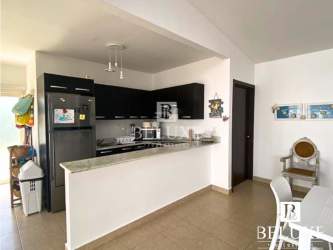 Fully equipped kitchen with granite countertop and black cabinets in Ibiza Beach Residences