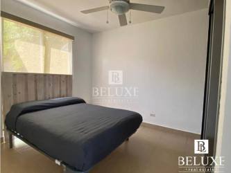 Bright bathroom with tiled walls, vanity sink and full mirror in Ibiza Beach house