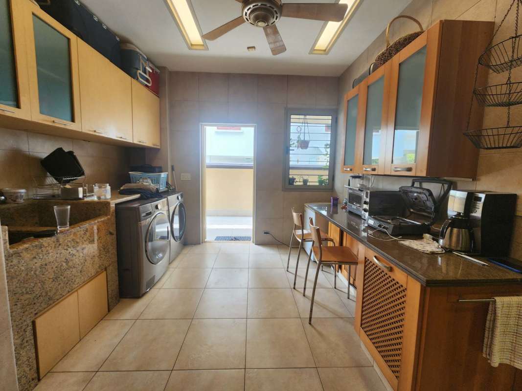 Spacious luxury kitchen with marble island, built-in appliances, at Costa del Este mansion Panama