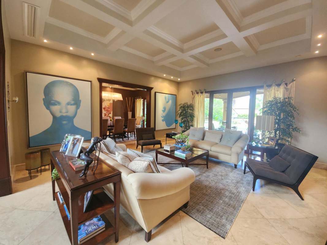 Elegant living room with marble floors, large windows, coffered ceiling at Balmoral mansion Costa del Este Panama City