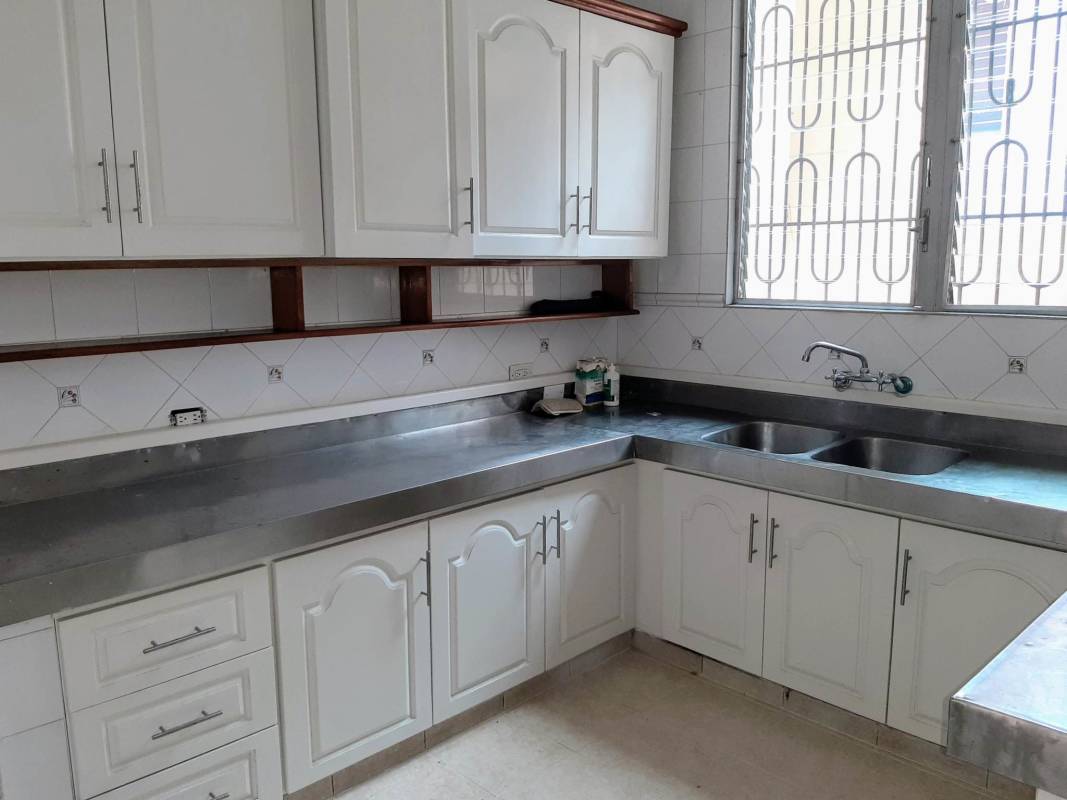 Spacious kitchen with tile counter cabinetry and window in rental house San Francisco Panama
