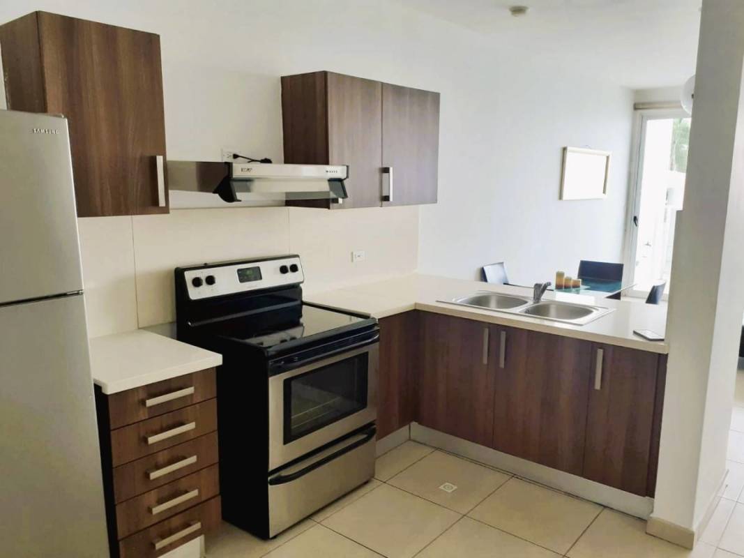 Modern kitchen with stainless steel appliances, open dining area at PH Oasis on the Bay