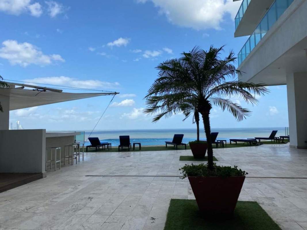 Bright bedroom with TV mount, large window overlooking Punta Pacifica cityscape