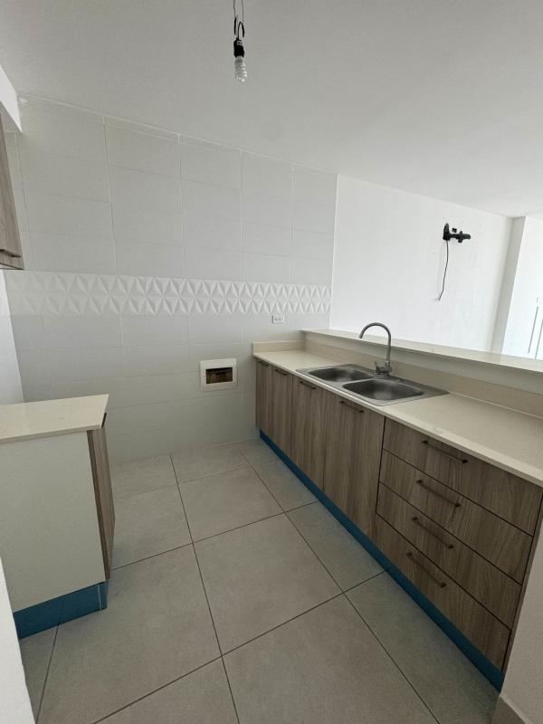 Contemporary kitchen with wood grain cabinets and tile backsplash PH Vivendi Green Panama