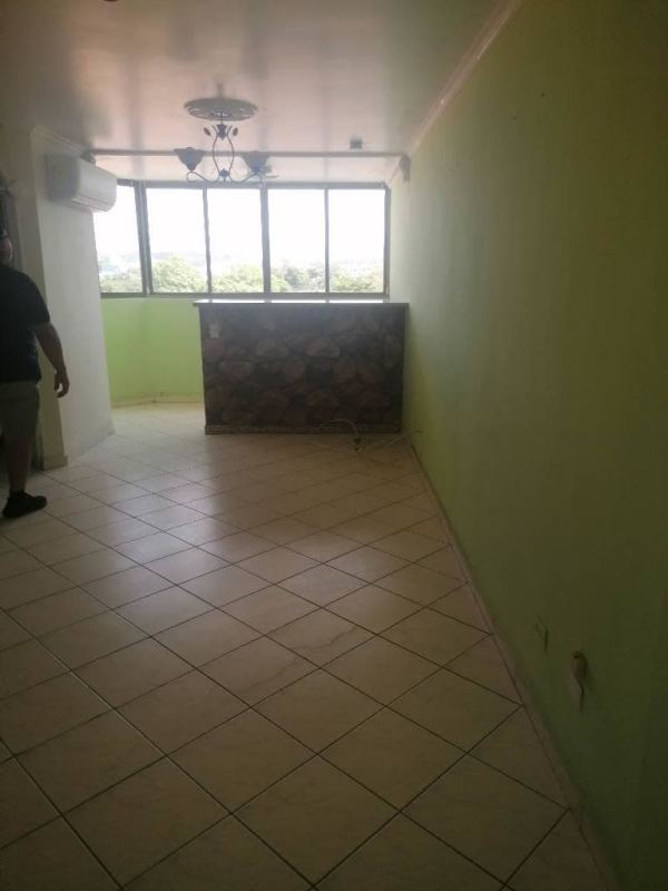 Multi-story pink apartment complex with balconies and landscaped entry in Don Bosco Panama City