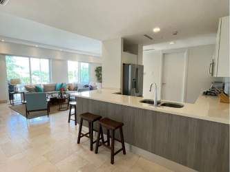 Contemporary open kitchen with island and bright living room, luxury beachfront condo Puntarena Buenaventura Panama