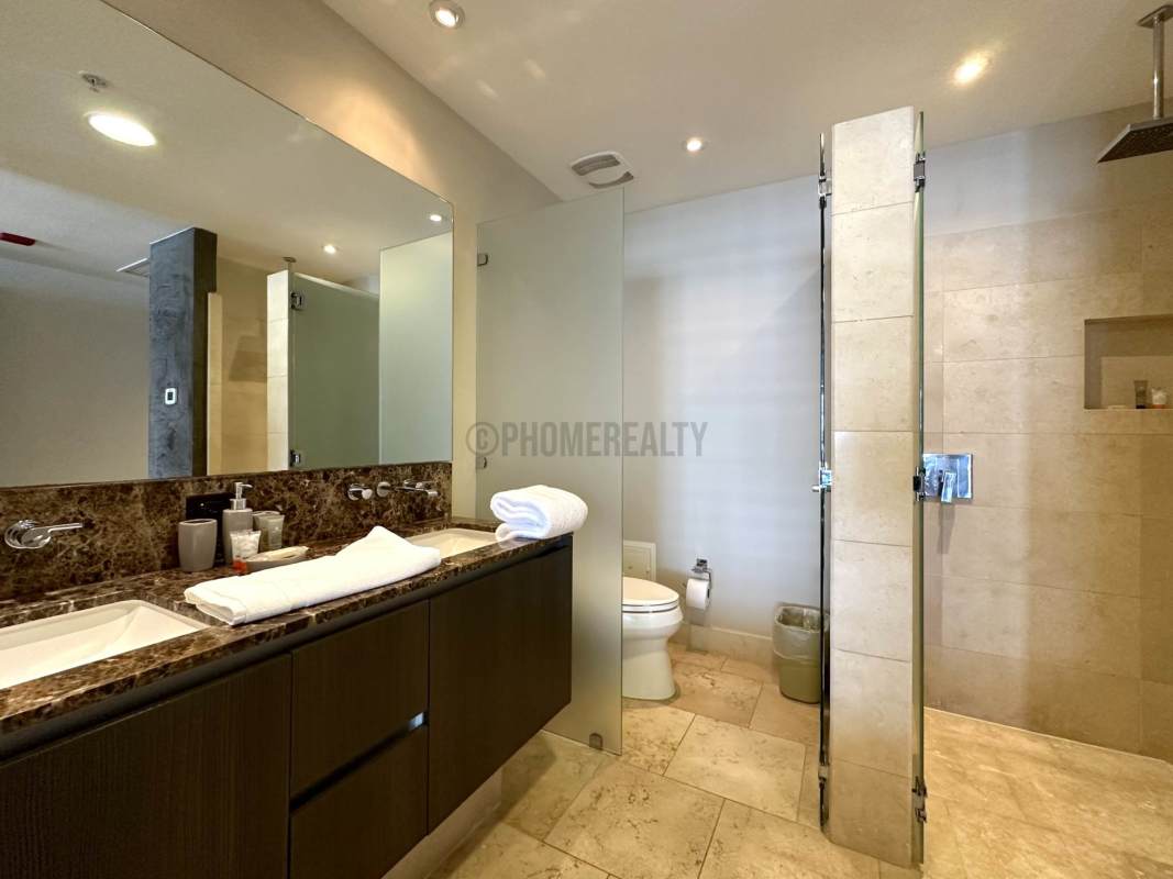 Modern kitchen with granite counters and Italian cabinets in luxury studio condo