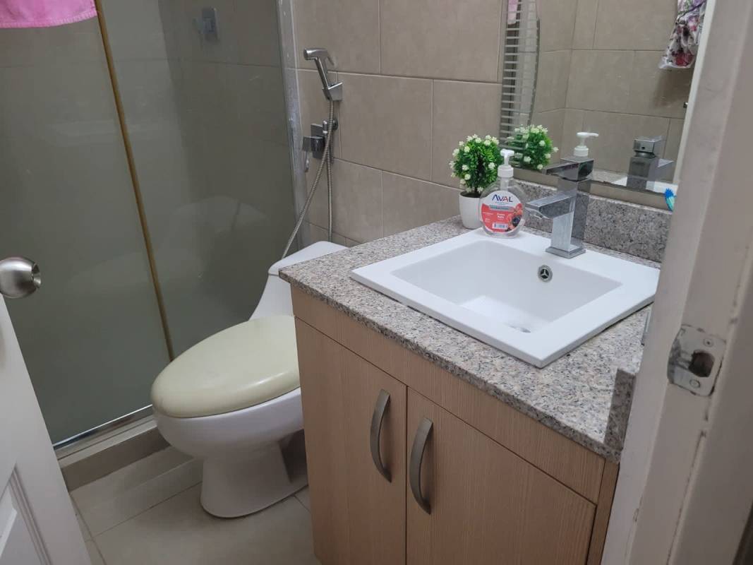 Bathroom with granite vanity and glass shower enclosure PH Creta Chanis Panama
