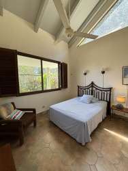 Living room with vaulted beam ceilings, garden views in luxury mountain property El Valle Panama