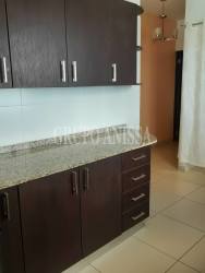 Kitchen with granite countertops and dark wood cabinets in PH Playa Blanca Panama