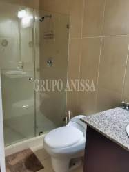 Modern bathroom with glass shower enclosure and granite countertop in PH Playa Blanca Panama