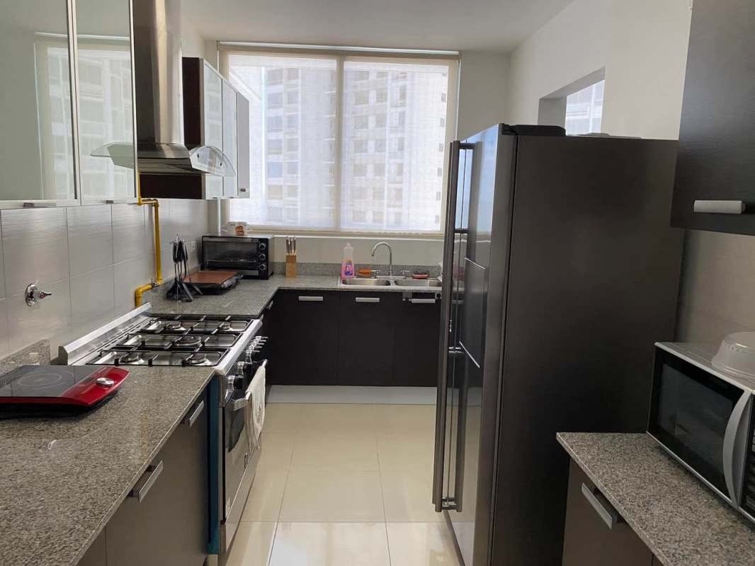 Open-plan living-dining area with panoramic windows and ceramic tile floors at PH Waterfalls Panama