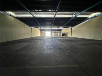 Spacious empty interior of industrial warehouse with skylights in Colón Free Zone Panama