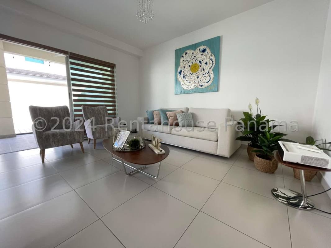 Spacious living room with large windows, modern tile flooring, and neutral decor in PH Altos del Parque