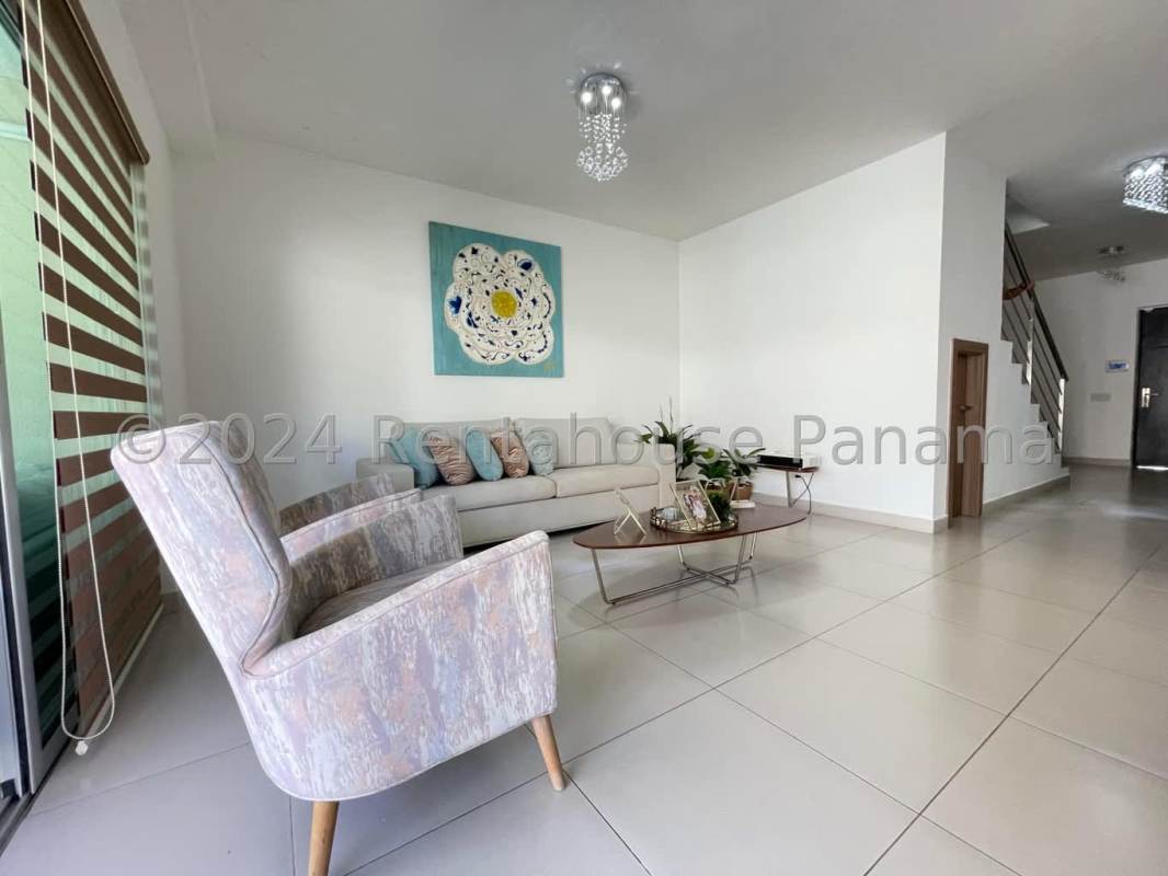 Outdoor covered terrace with seating area, tiled floor, garden view in PH Altos del Parque Panama