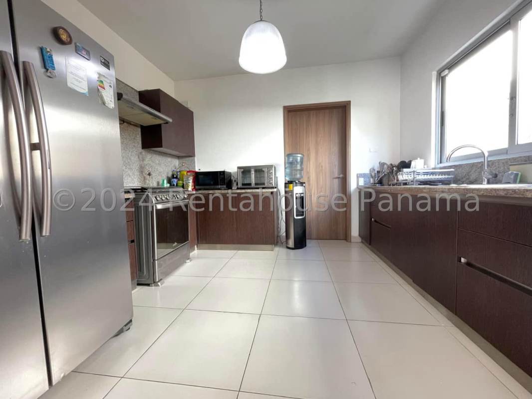 Spacious bedroom with large window, neutral decor, ensuite bathroom in PH Altos del Parque Panama