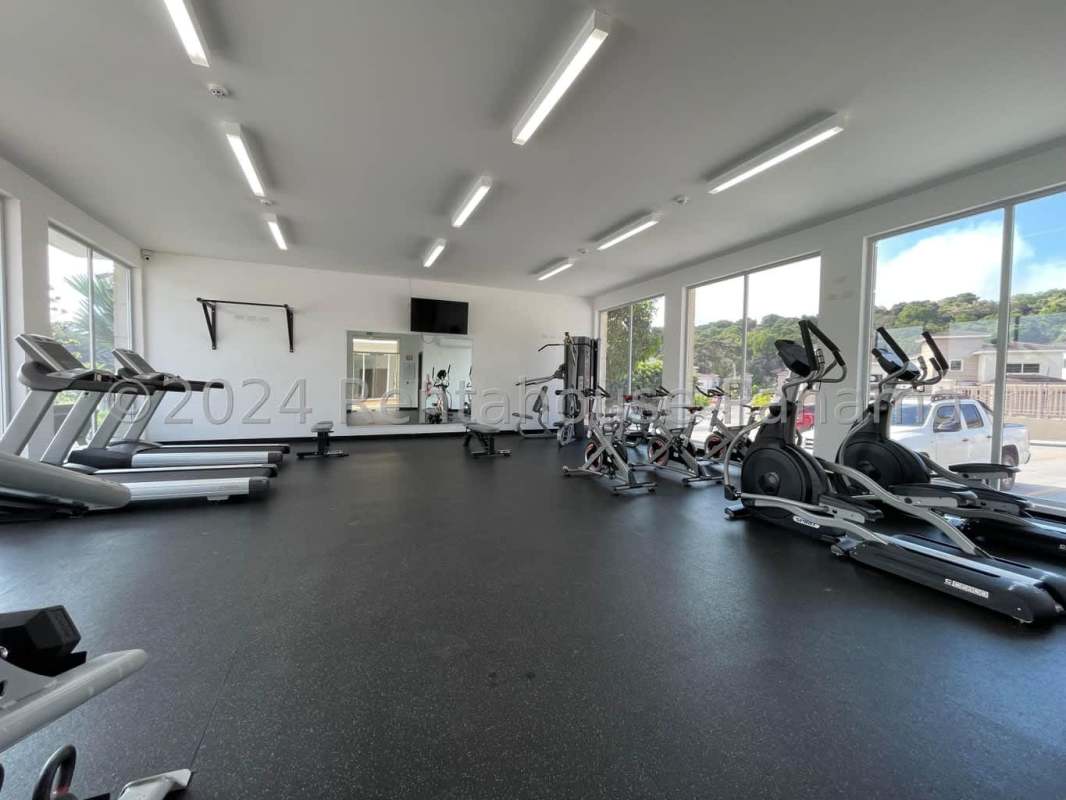 Modern outdoor pool with jacuzzi, lounge chairs, landscape garden in PH Altos del Parque