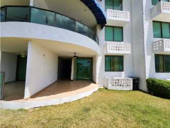Curved balcony with glass rail overlooking gardens at Los Balcones Playa Blanca Panama