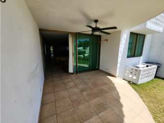 Covered patio with ceiling fan outside Playa Blanca resort condo Panama