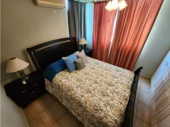 Bedroom with double bed, window AC curtains in Los Balcones Playa Blanca