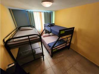 Bedroom with built-in closet, AC unit, ceiling fan at Playa Blanca resort Panama