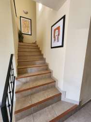 Covered tropical terrace with seating at frontline golf house in Coronado Panama