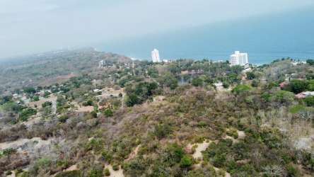 Coastal aerial showing ocean, greenery, and neighboring developments at Boca Corona Panama