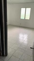 Empty bedroom with ceramic tile floor and louvered window in affordable Penonomé rental