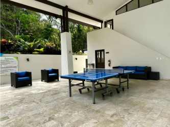 Modern open concept living and dining area with garden views in Panama Pacifico