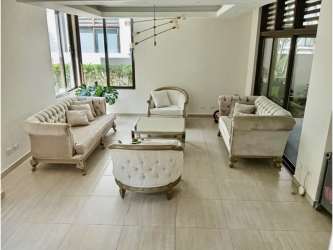 Living area with large windows, neutral tile floor opening to terrace PH Nativa Panama