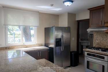 Covered balcony with panoramic golf course views at Tucán Country Club home