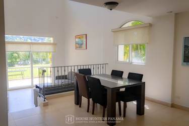Dining area with large windows and garden views in luxury house Panama